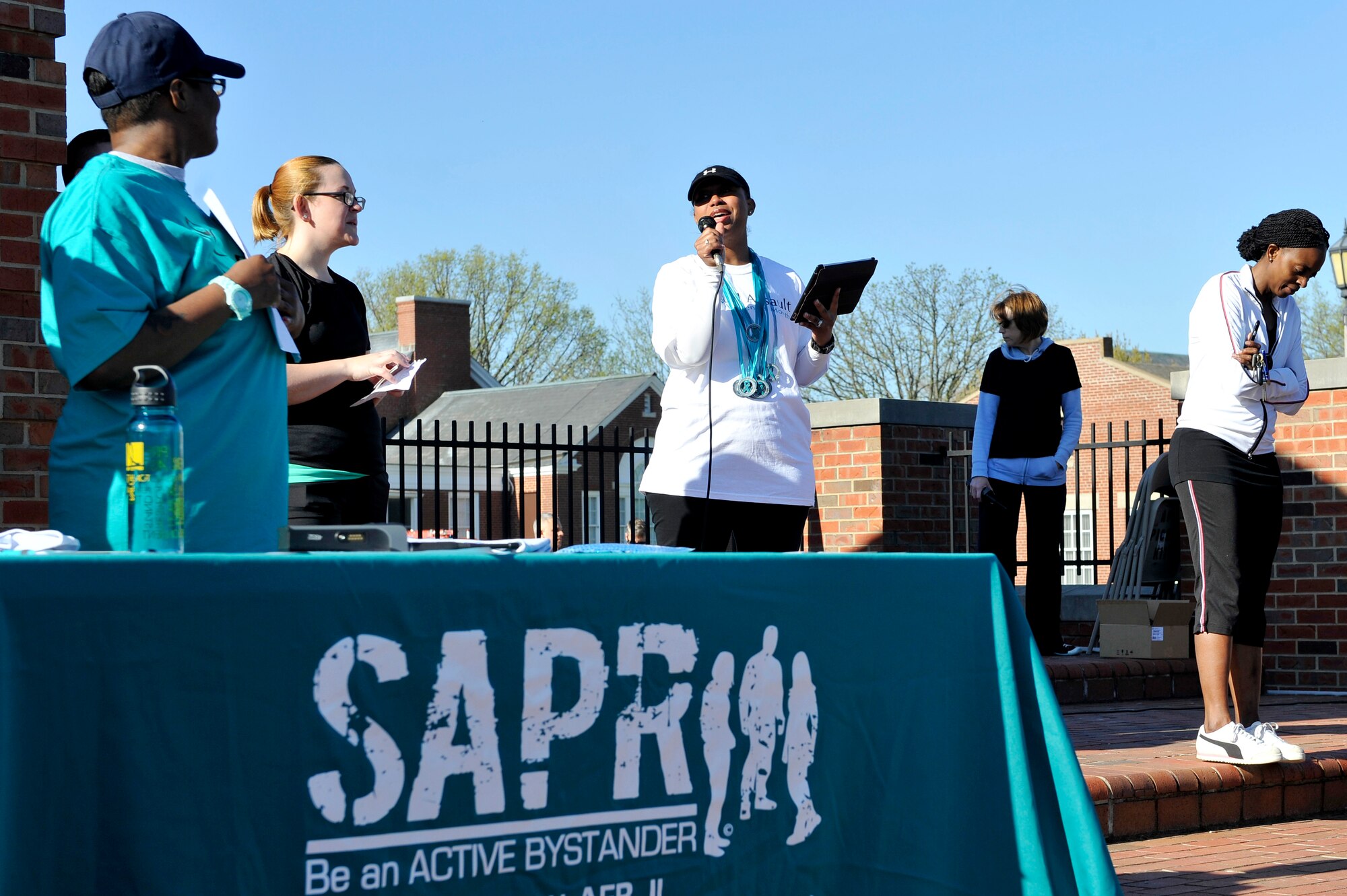 Master Sgt. Pamela King gave opening remarks during a 5k run April 25, 2014 at Scott Air Force Base, Ill. The 5k run was held to help raise sexual assault awareness and prevention. Master Sgt. Pamela King hosted this event and there were 325 participants. (U.S. Air Force photo/ Airman 1st Class Kiana Brothers)