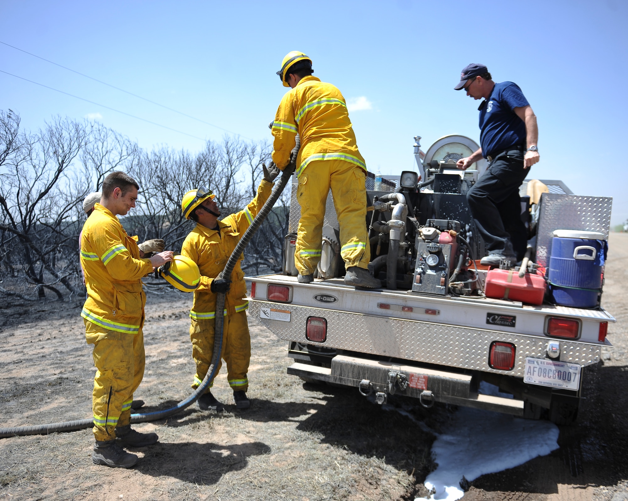 Dyess Air Force Base firefighters re-service a brush truck April 28, 2014, at Camp Barkeley near Buffalo Gap, Texas. Brush trucks are used by the firefighters to quickly attack fires that require a more agile vehicle. Dyess fire crews teamed with other local agencies to extinguish a wildfire that spread across 1,600 acres. (U.S. Air Force photo by Airman 1st Class Kedesha Pennant/Released)