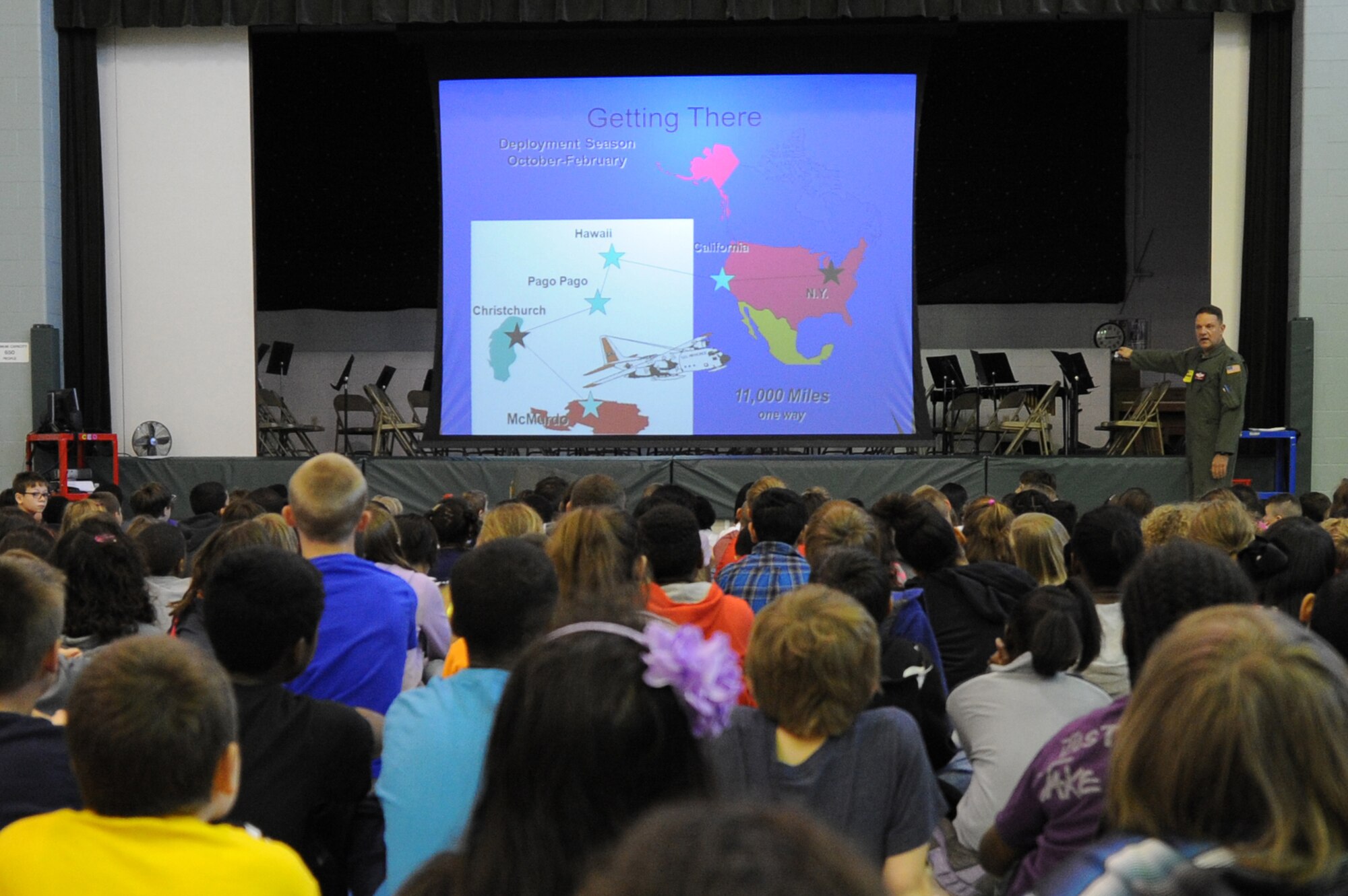 Lt. Col. William "Sal" Salvaggio, 109th Airlift Wing LC-130 instructor navigator, shows children at Scott Elementary School how his team gets to their Antarctic missions during a presentation on April 22, 2014 at Scott Air Force Base, Ill. Salvaggio showed the students his gear, told them about his plane, and told them why they go to Antarctica. (U.S. Air Force photo by Senior Airman Sarah Hall-Kirchner/Released)