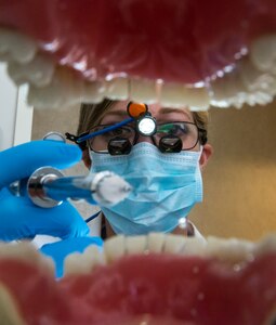 Capt. Mary Sorrentino, 628th Aerospace Medicine Squadron general dentist, demonstrates a dental procedure on a life-size mouth display Apr. 16, 2014, at the 628th Medical Group dental clinic on Joint Base Charleston – Air Base, S.C. Sorrentino bends the needle on the syringe to allow for an easier and safer injection while working on a patient. (U.S. Air Force photo/ Airman 1st Class Clayton Cupit)