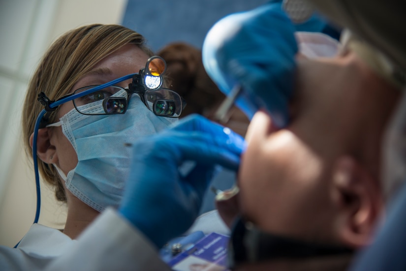 Capt. Mary Sorrentino, 628th Aerospace Medicine Squadron general dentist, performs a routine dental examination on Airman 1st Class Craig Luce, 437th Ariel Port Squadron cargo processor Apr. 16, 2014, at the 628th Medical Group dental clinic on Joint Base Charleston – Air Base, S.C. Dentists use a variety of tools and equipment to allow them better vision of the patient’s teeth while they work. (U.S Air Force photo/ Airman 1st Class Clayton Cupit)