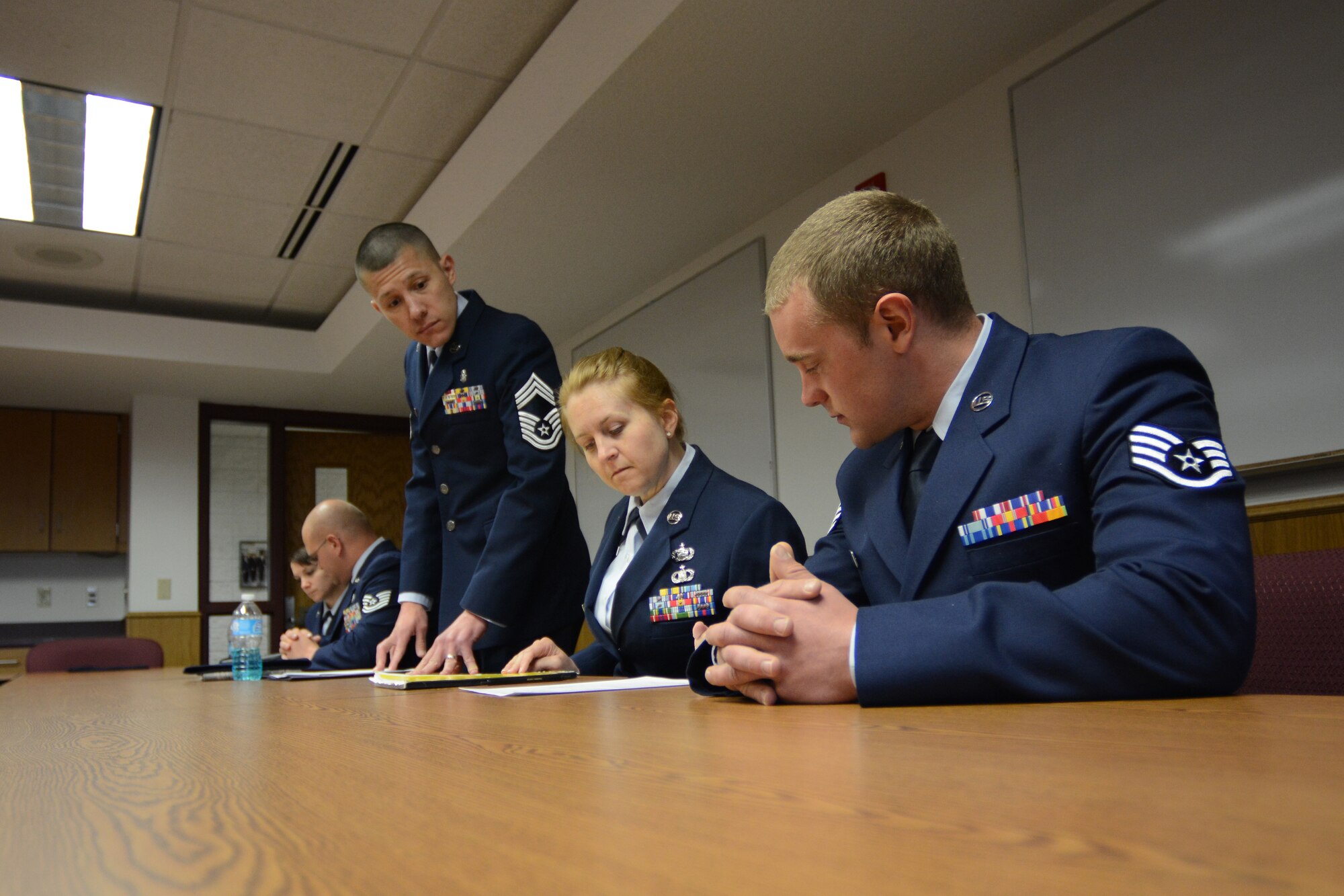 Five Wisconsin Air National Guard Airmen practice sitting on a board the final day of the State Enlisted Development Program at Volk Field Air National Guard Base, Wis., April 24, 2014. After 12 months of training during unit training assemblies, the group was put to the test with various scenarios they will encounter as ANG leaders. (Air National Guard photo by Senior Airman Andrea F. Liechti)