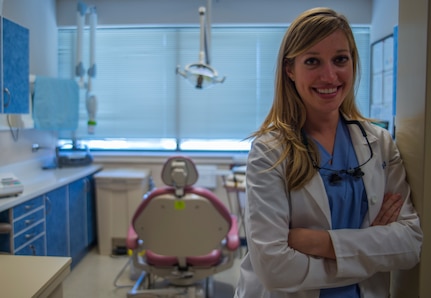 Capt. Mary Sorrentino, 628th Aerospace Medicine Squadron general dentist, stands in front of her second “office” Apr. 16, 2014, at the 628th Medical Group dental clinic on Joint Base Charleston – Air Base, S.C. Sorrentino is credentialed to provide a variety of procedures including the basics such as fillings and crowns to more unique ones such as root canals for canines and providing ear acupuncture pain removal techniques. (U.S. Air Force photo/ Airman 1st Class Clayton Cupit)