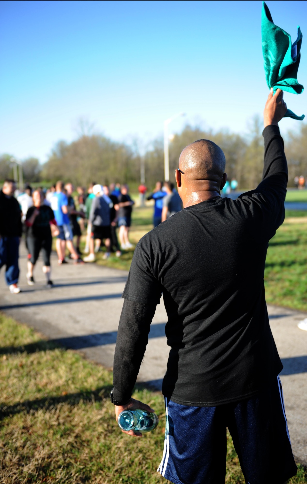 Master Sgt. Randolph Wyatt, 509th Munitions Squadron first sergeant, cheers on runners during the 5K Race for Respect at Whiteman Air Force Base, Mo., April 25, 2014. The day was dedicated to Sexual Assault Prevention and Response, which included training for all enlisted Airmen, officers and Department of Defense civilians. (U.S. Air Force photo by Airman 1st Class Joel Pfiester/Released)