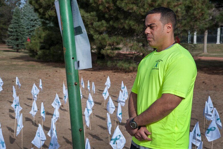 PETERSON AIR FORCE BASE, Colo. – A Team Pete member reads one of the displays during the Peterson Sexual Assault Awareness Month Reflection Walk April 25 in Eagle Park. Each of the 192 flags represent an adult victim of sexual assault from the Peterson Air Force Base community over the past five years. The walk also included stories from sexual assault victims and a banner walkers could sign to show support for victims and speak out against sexual assault. Other activities during the month included a 5K awareness run/walk, the Silent Witness Initiative and the Clothesline Project, a display of shirts with messages and illustrations designed by survivors of sexual violence or by someone who loves a victim to increase awareness of the impact of sexual violence. (U.S. Air Force photo/Craig Denton)