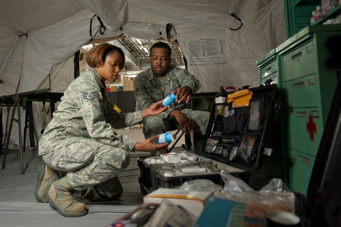 Staff Sgt. Shanika Stewart (left), 99th Medical Operations Squadron medical technician, and Senior Airman Ja-Micheal Smith (right), 99th Aerospace Medicine Squadron medical technician, inventory a deployable medicine case April 24, 2014 at Nellis Air Force Base, Nev.  The ATC is designed to provide outpatient services and initial trauma response care in remote locations. (U.S. Air Force photo by Airman 1st Class Timothy Young)