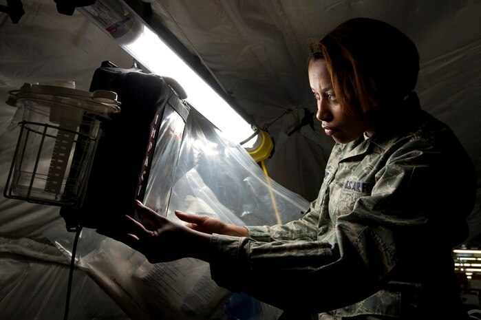 Staff Sgt. Shanika Stewart, 99th Medical Operations Squadron medical technician, adjusts IMPACT portable suction unit inside an Utilis Air Transportable Clinic April 24, 2014 at Nellis Air Force Base, Nev. The ATC is a deployable medical tent to support 300 to 500 patients requiring outpatient care in a remote area for a 30-day period without any resupplies. (U.S. Air Force photo by Airman 1st Class Timothy Young)