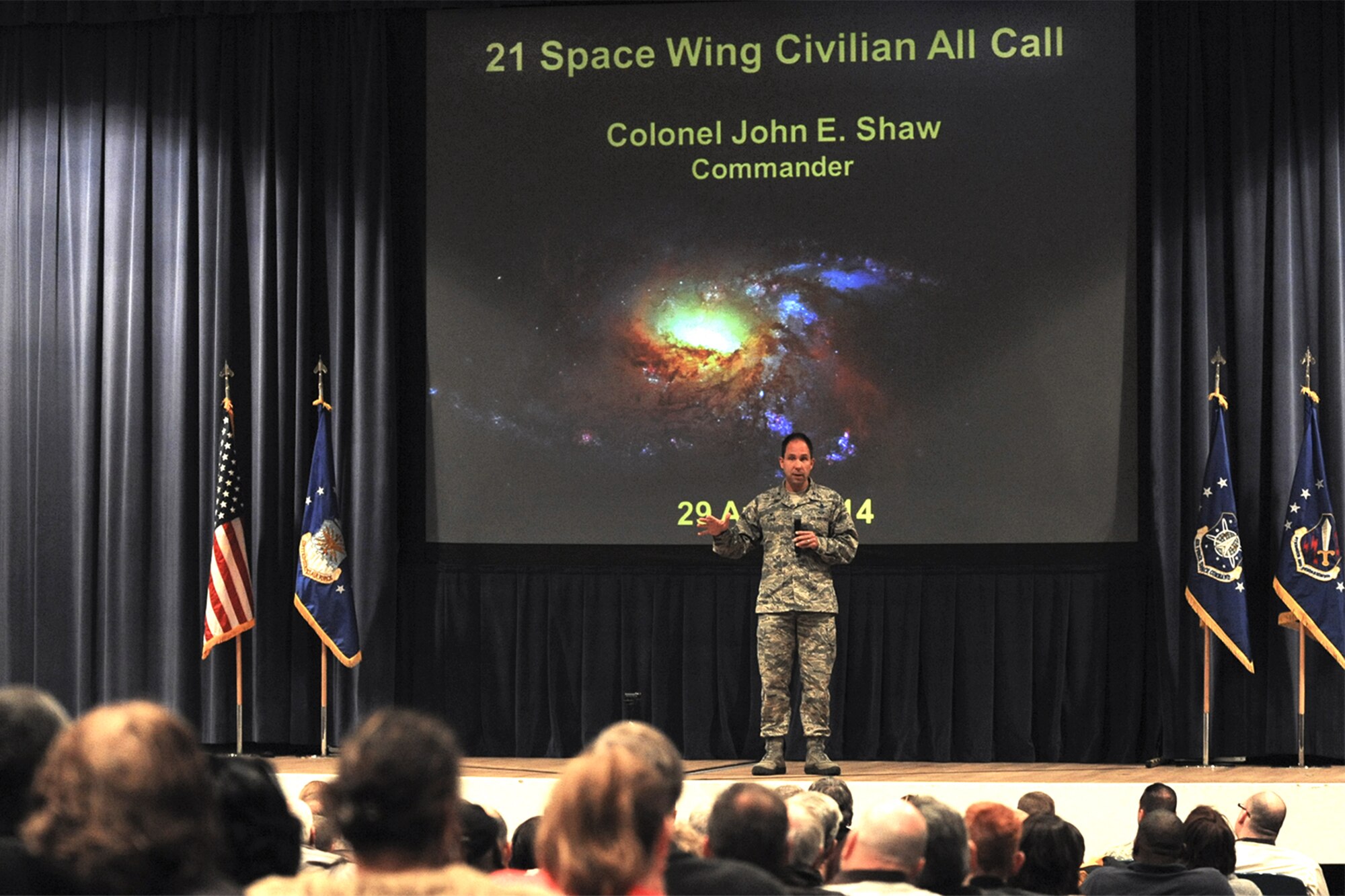 PETERSON AIR FORCE BASE, Colo. – Col. John Shaw, 21st Space Wing commander, addresses an audience of more than 400 in-person and 300 virtual attendees at a civilian all-call April 29. The topics included opportunities and ideas for efficient operations, civilian and military force management programs, marijuana legalization impacts, civilian leave, his command philosophy and upcoming base events. (U.S. Air Force photo/Staff Sgt. Jacob Morgan)
