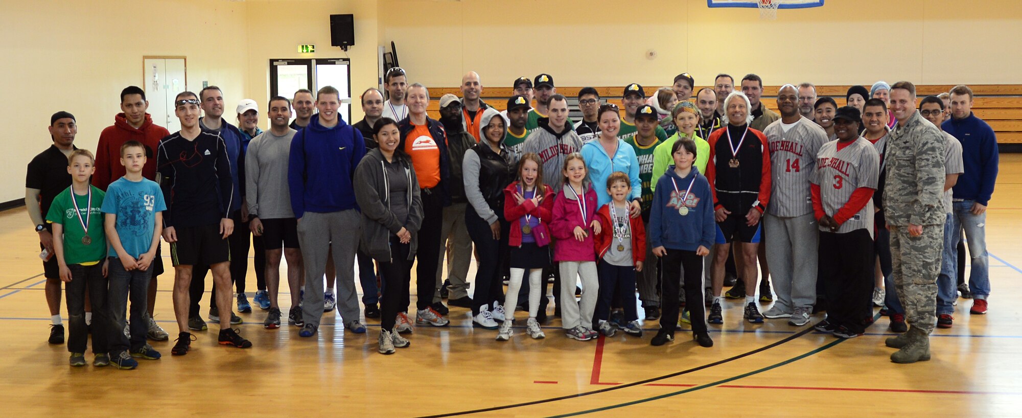 Team Mildenhall members pose for a group photo after completing the 100th Force Support Squadron’s duathlon April 26, 2014, on RAF Mildenhall, England. After the run, the 100th FSS held an award ceremony to identify the top three female and male finishers of the event. (U.S. Air Force photo by Airman 1st Class Jonathan Light/Released)