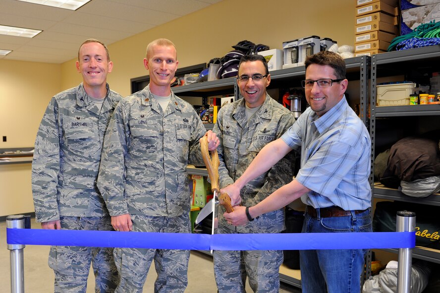 Col. Bill Liquori, 50th Space Wing commander (center right), officially opened the remodeled Schriever Outdoor Recreation and Information Travel and Tickets warehouse April 25, 2014.  Col. Brian Barthel, 50th Space Wing Mission Support Group commander, Maj. Justin Long, 50th Force Support Squadron commander, and Chad McNamee, SB Construction project manager were on hand to help cut the ceremonial ribbon. (U.S. Air Force photo/Christopher DeWitt)