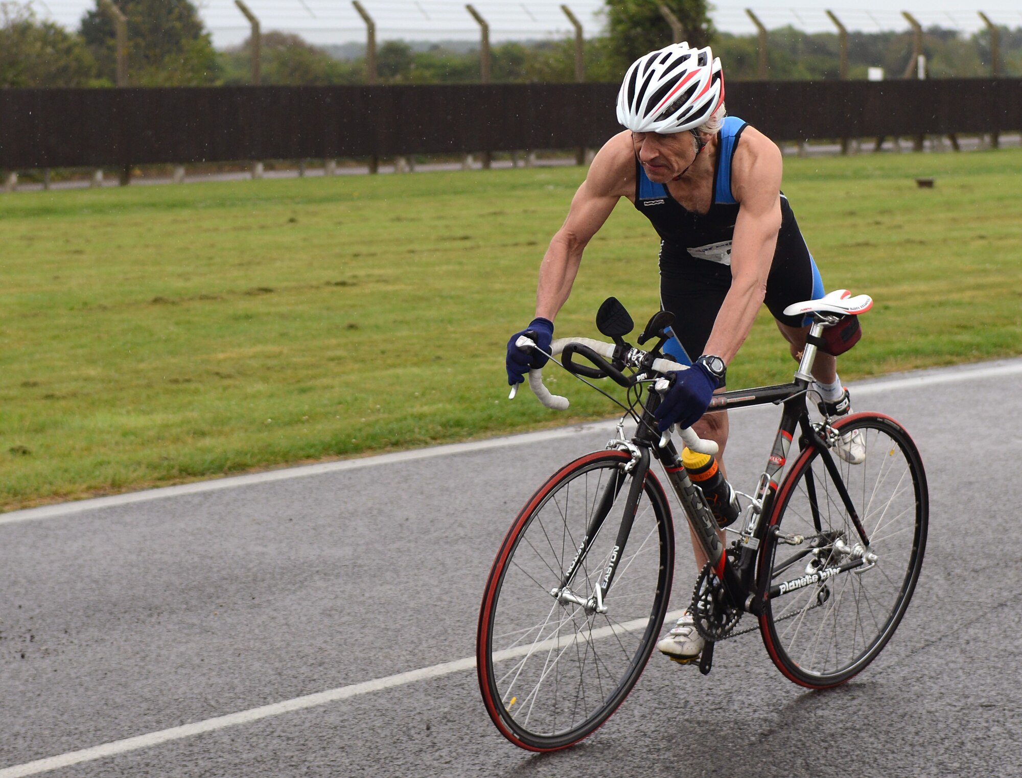 U.S. Air Force Cliff Bailey, 100th Civil Engineer Squadron sheet metal welder from Thetford, England, jumps off his bike at a transition point during the 100th Force Support Squadron’s duathlon April 26, 2014, on RAF Mildenhall, England. Bailey completed the race in 1st place with a time of 1 hour, 24 minutes, 27 seconds. (U.S. Air Force photo by Airman 1st Class Jonathan Light/Released)