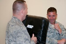 Tech. Sgt. Justin Silva (right), Air Force Space Command Security Forces, participates in a baton refresher course April 23, 2014, at Schriever Air Force Base, Colo. The mandatory course served as an annual certification for security forces Airmen. (U.S. Air Force photo/Senior Airman Naomi Griego) 