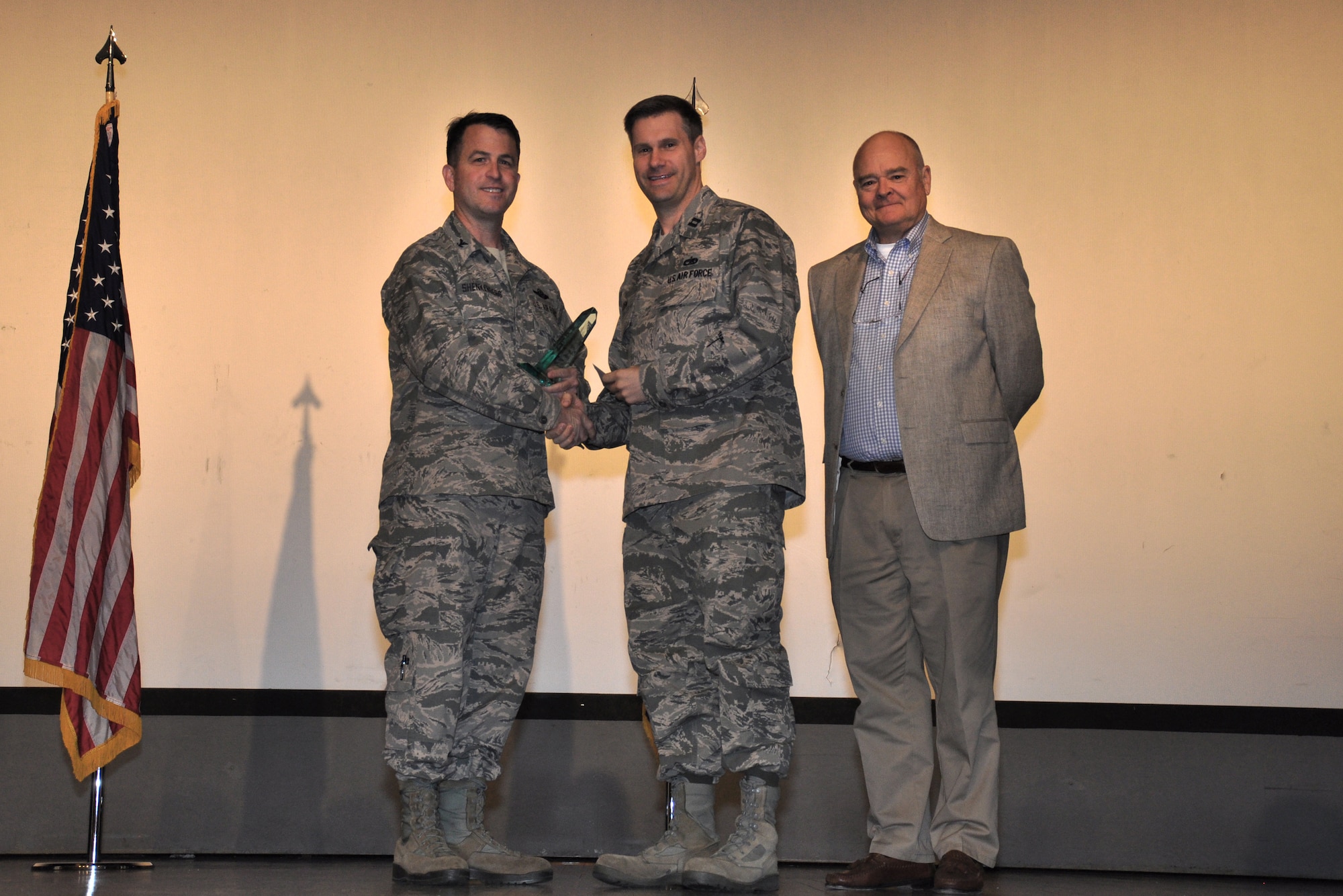Capt. Benjamin Hazen, 911th Air Refueling Squadron, is recognized as CGO of the Quarter by Col. Craig Shenkenberg, 916th Air Refueling Wing vice-commander, and Dr. Mike Gooden, 916th Air Refueling Wing honorary commander. All 2013 yearly and fourth quarterly award winners were recognized during the April drill weekend. (U.S. Air Force photo/Staff Sgt. Alan Abernethy)