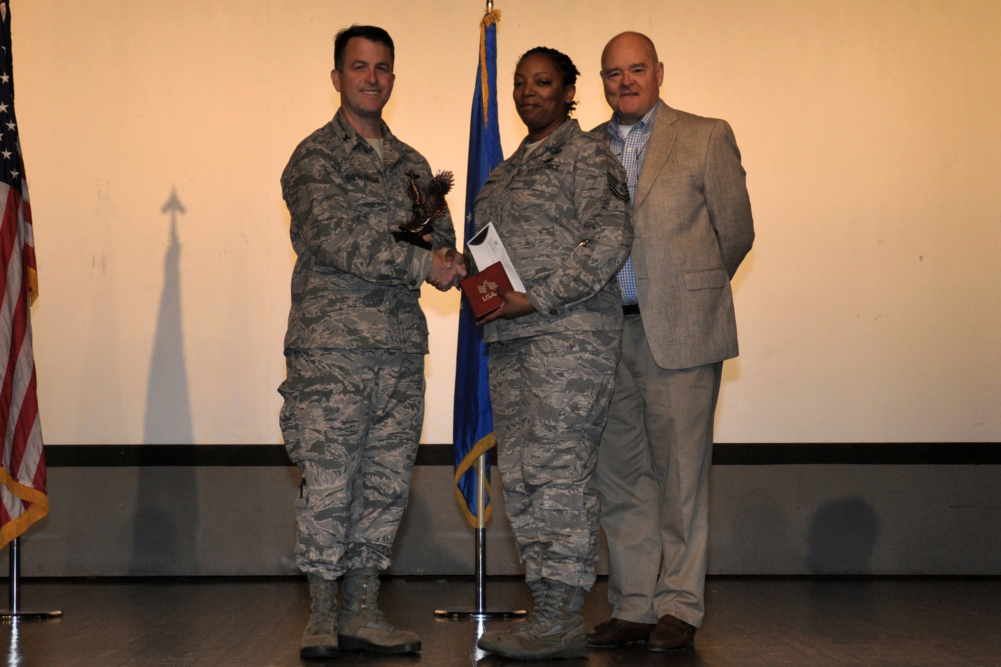 Tech. Sgt. Janell Johnson, 916th Air Refueling Wing, is recognized as NCO of the Year by Col. Craig Shenkenberg, 916th Air Refueling Wing vice-commander, and Dr. Mike Gooden, 916th Air Refueling Wing honorary commander. All 2013 yearly and fourth quarterly award winners were recognized during the April drill weekend. (U.S. Air Force photo/Staff Sgt. Alan Abernethy) 