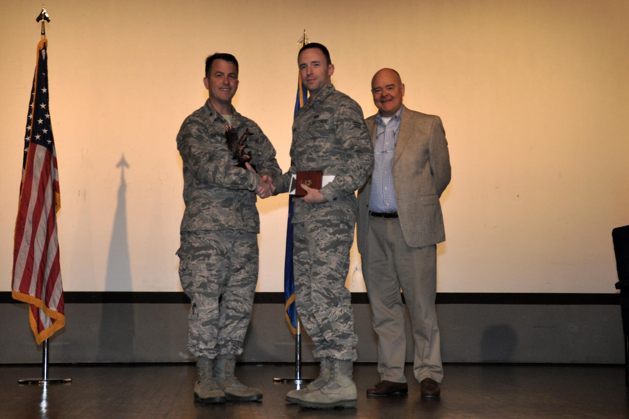 Senior Airman Michael Munton, 916th Operations Support Squadron, is recognized as Airman of the Year by Col. Craig Shenkenberg, 916th Air Refueling Wing vice-commander, and Dr. Mike Gooden, 916th Air Refueling Wing honorary commander. All 2013 yearly and fourth quarterly award winners were recognized during the April drill weekend. (U.S. Air Force photo/Staff Sgt. Alan Abernethy)