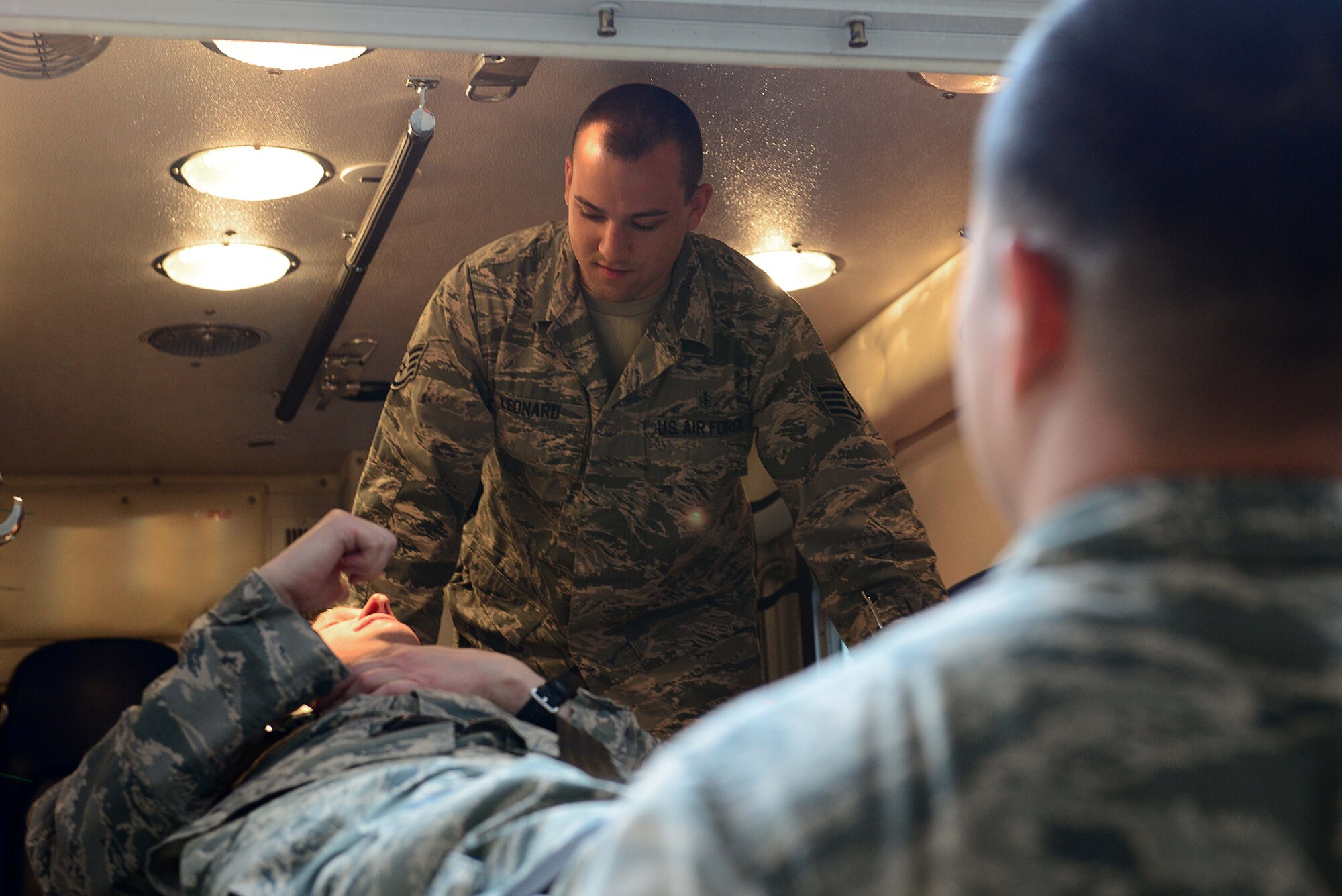 U.S. Air Force Staff Sgt. Christopher Leonard, 633rd Medical Operations Squadron paramedic, simulates ambulatory care of a patient at Langley Air Force Base, Va., April 29, 2014. Beginning May 1, the 633rd MDOS paramedics will transfer operations to the Langley AFB fire department, improving response times and the operational effectiveness of emergency response teams. (U.S. Air Force photo by Airman 1st Class Kimberly Nagle/Released)
