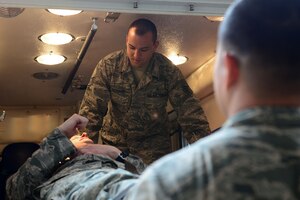 U.S. Air Force Staff Sgt. Christopher Leonard, 633rd Medical Operations Squadron paramedic, simulates ambulatory care of a patient at Langley Air Force Base, Va., April 29, 2014. Beginning May 1, the 633rd MDOS paramedics will transfer operations to the Langley AFB fire department, improving response times and the operational effectiveness of emergency response teams. (U.S. Air Force photo by Airman 1st Class Kimberly Nagle/Released)