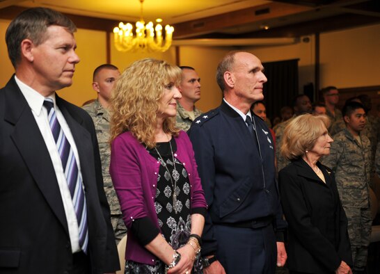 The family of Robert Keffer stands as his retirement certificate is read aloud April 25, 2014, at Ramstein Air Base, Germany. Keffer retired after serving 57 years of service. Until his retirement, Keffer had been the Plans Programs and Resources chief to the 86th Communications Squadron, the largest communications squadron within the U.S. Air Force. He supported a major command, one numbered Air Force, three wings and 125 associated units. (U.S. Air Force photo/Senior Airman Hailey Haux)