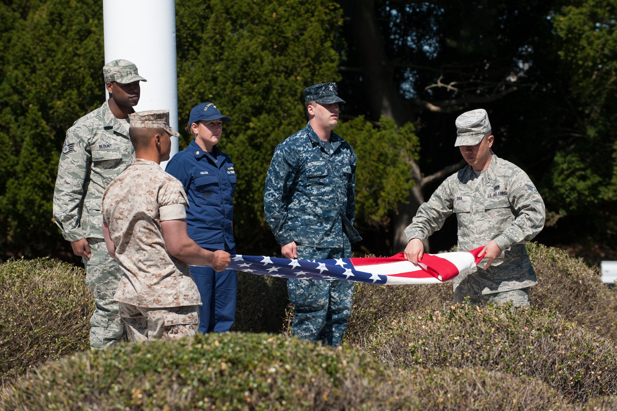 Members of the Joint Base McGuire-Dix-Lakehurst, N.J., flag detail, fold the flag at a Retreat Ceremony Apr. 24, 2014, at JB MDL. All five branches took part in the cannon firing and lowering of the flag at Sharpe Field. (U.S. Air Force photo by Russ Meseroll/Released)
