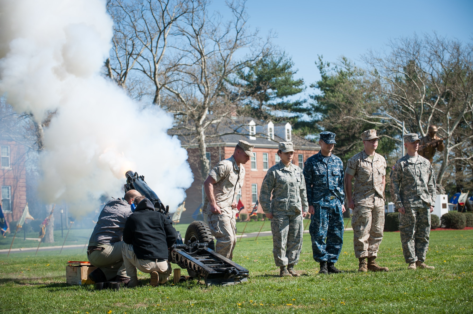Members of the cannon firing squad, fire the garrison cannon during a Retreat Ceremony Apr. 24, 2014, at Joint Base McGuire-Dix-Lakehurst, N.J. All five branches took part in the cannon firing and lowering of the flag at Sharpe Field. (U.S. Air Force photo by Russ Meseroll/Released)