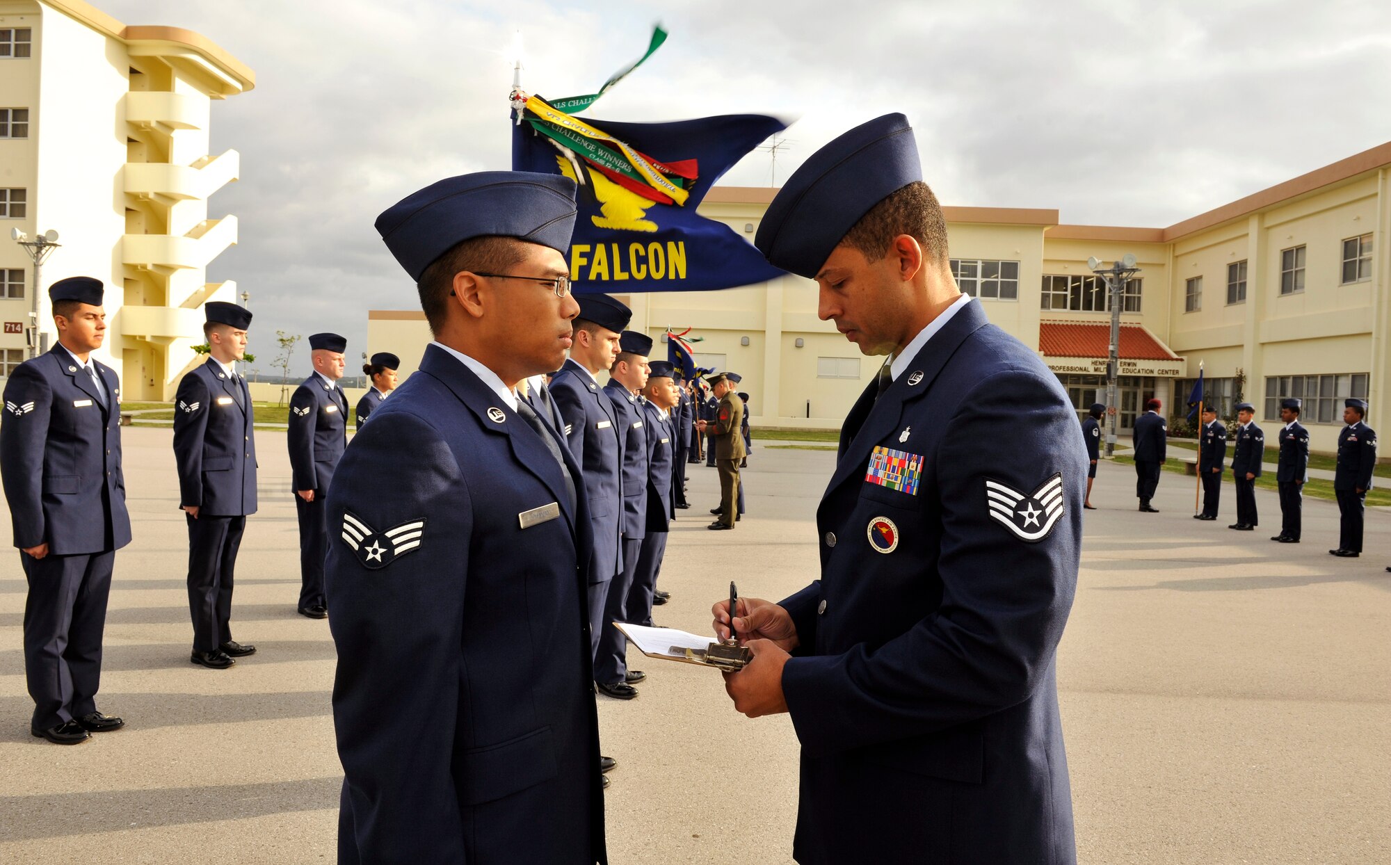 U.S. Air Force Staff Sgt. Carlton Holt, Professional Military Education instructor, writes a discrepancy during a service dress uniform inspection on Kadena Air Base, Japan, April 29, 2014. During the five weeks of Airman Leadership School, students have three inspections in their airman battle uniform, service dress uniform, and blues to reinforce the principles of discipline and attention to detail. (U.S. Air Force photo by Naoto Anazawa)