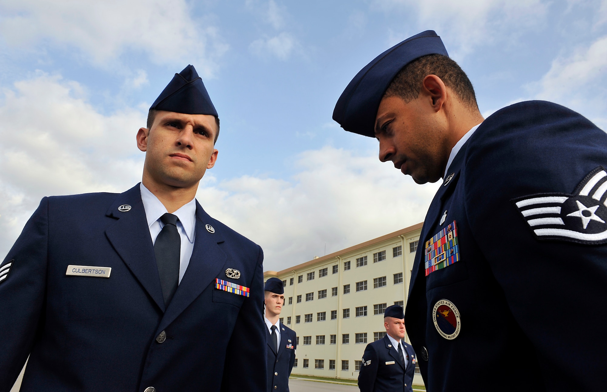 U.S. Air Force Staff Sgt. Carlton Holt, Professional Military Education instructor, inspects Senior Airman Stephen Culbertson, 18th Munitions Squadron munitions system technician, during a service dress uniform inspection on Kadena Air Base, Japan, April 29, 2014. Airman Leadership School is the first PME that enlisted Air Force members encounter. ALS focuses on developing leadership abilities, the profession of arms, and building effective communication. (U.S. Air Force photo by Naoto Anazawa)