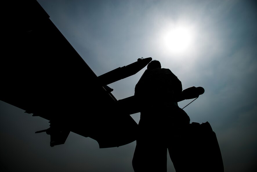 Senior Airman Juan Gonzalez, a 25th Aircraft Maintenance Unit weapons load crew member, secures a missle on an A-10 during the 2014 Korean Peninsula Weapons Loading Competition April 26, at Osan Air Base, Republic of Korea. For the competition, teams have a time limilt of 20 minutes to complete all requirements. (U.S. Air Force photo by Staff Sgt. Jake Barreiro)