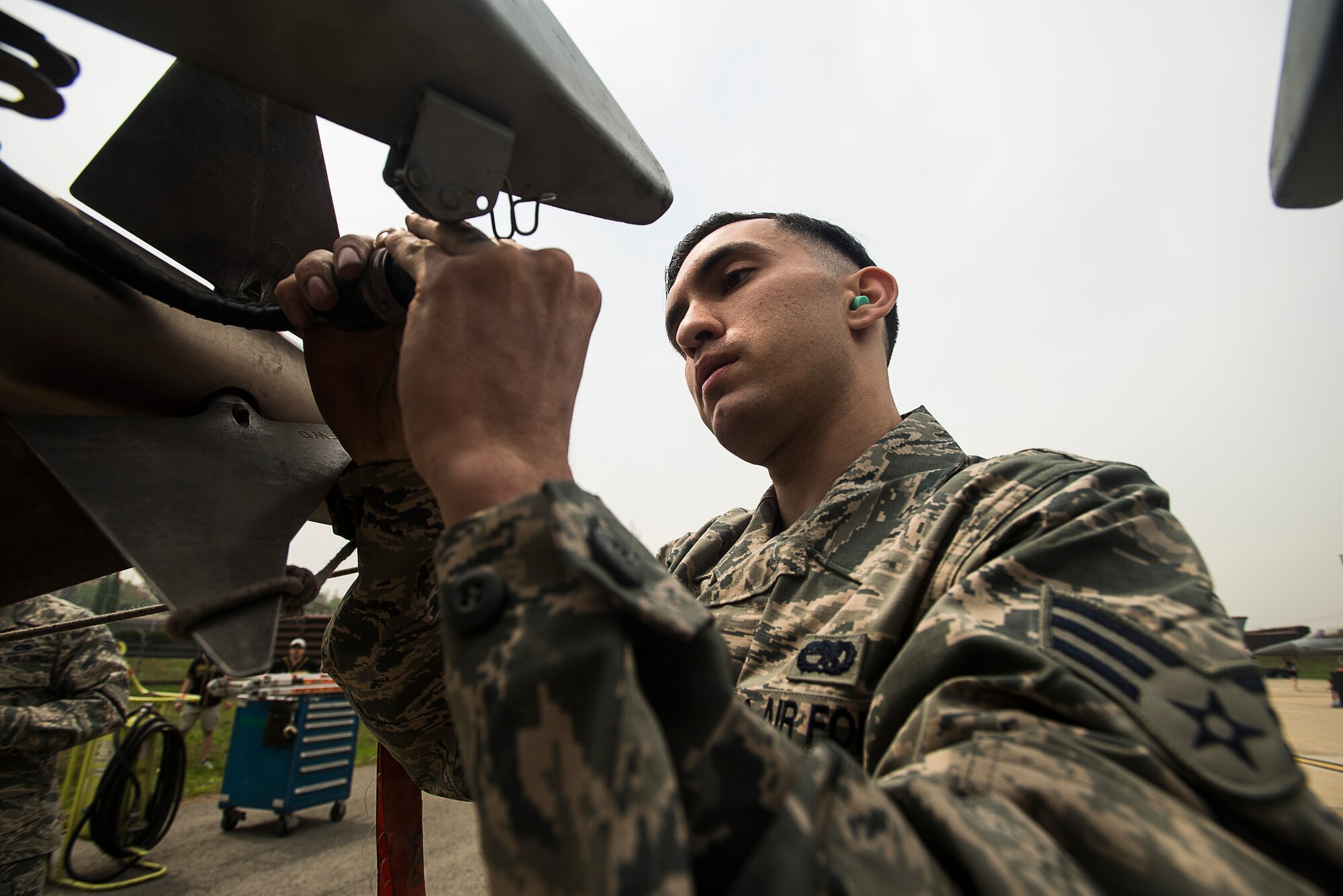 Senior Airman Juan Gonzalez, a 25th Aircraft Maintenance Unit weapons load crew member, secures a missle on an A-10 during the 2014 Korean Peninsula Weapons Loading Competition April 26, 2014, at Osan Air Base, Republic of Korea. The 25th AMU's team loaded weapons on an A-10, while the other three teams loaded F-16s. (U.S. Air Force photo by Staff Sgt. Jake Barreiro)