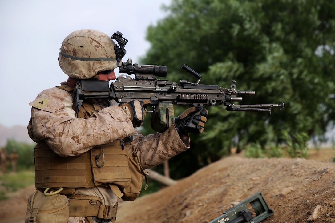 U.S. Marine Corps Lance Cpl. Jonathan Griffiths provides security with an M249 squad automatic weapon during a mission in Larr village in Afghanistan's Helmand province, April 25, 2014. Griffiths, a combat engineer, is assigned to 2nd Combat Engineer Battalion, 1st Battalion, 7th Marine Regiment.