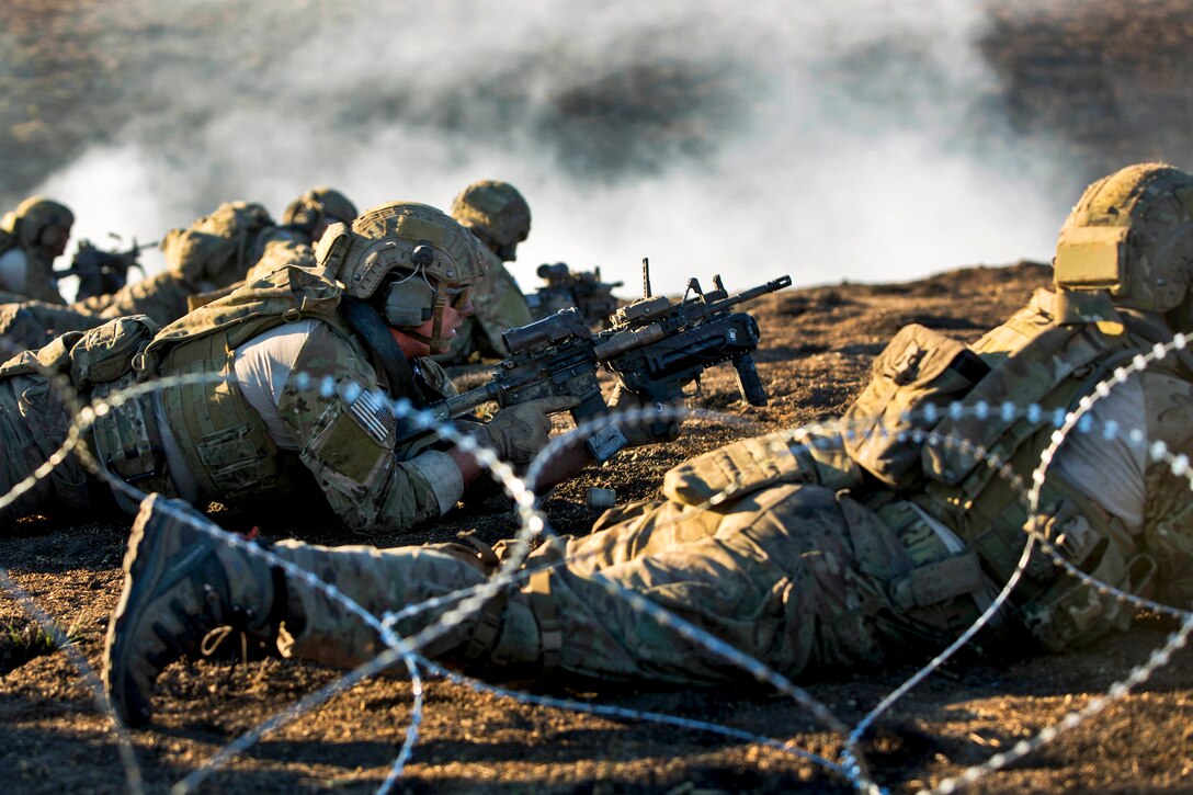 Army Rangers prepare to lay down suppressive fire during live-fire training on Fort Hunter Liggett, Calif., Jan. 23, 2014. The Rangers are assigned to Company B, 2nd Battalion, 75th Ranger Regiment. The training enables the soldiers to maintain proficiency on their tactical skills.  