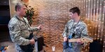 PETERSON AIR FORCE BASE, Colo. -- Airman 1st Class Brett Wells, 21st Communications Squadron (right) and Tech. Sgt. Andrew Decker, 21st Aerospace Medicine Squadron, participate in a guitar duel at The Club April 25. The duel was part of the Wing’s monthly Final Friday event. (U.S. Air Force photo/Craig Denton)