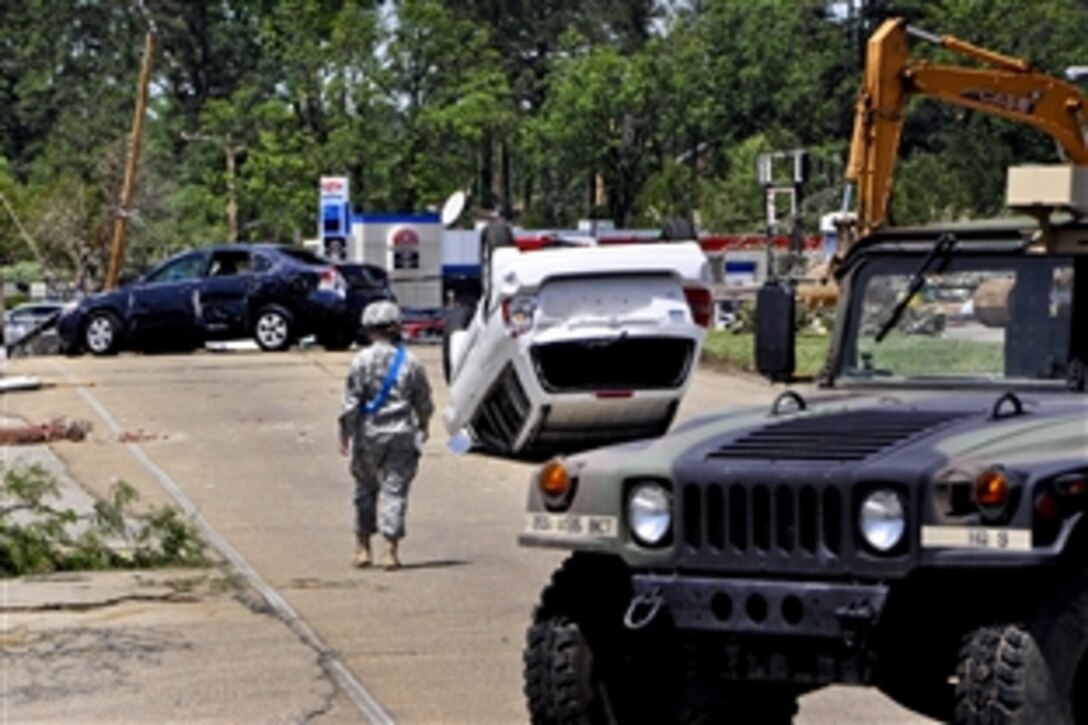 A Mississippi Guardsman surveys damage on several streets in Tupelo, Miss., April 29, 2014. About 50 Mississippi Guardsmen responded to help, performing a variety of missions, including traffic control, patrolling and assisting local law enforcement officers.