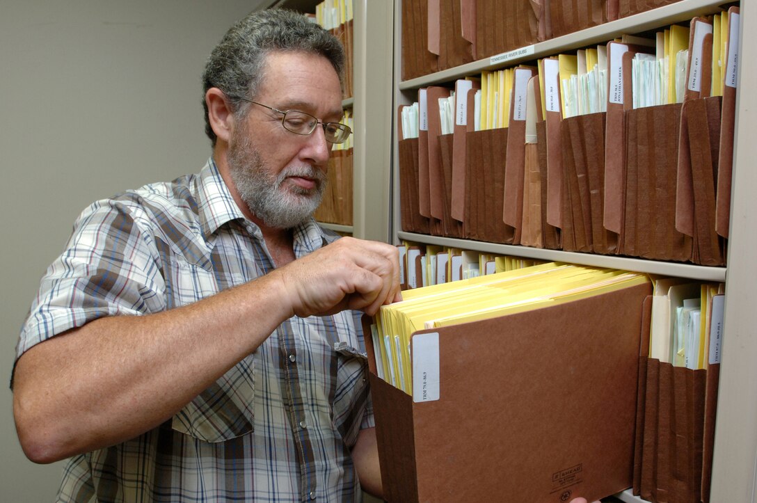 Gary Davis, regulatory official at the U.S. Army Corps of Engineers Nashville District Western Regulatory Field Office in Decatur, Ala., looks at files at the office July 29, 2014.