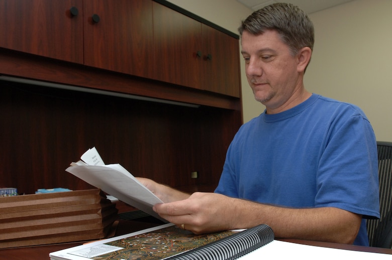 Eric Sinclair, regulatory official at the U.S. Army Corps of Engineers Nashville District Western Regulatory Field Office in Decatur, Ala., sorts through paperwork in his office July 29, 2014.