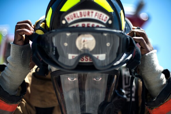 Airman 1st Class Keith Fussell dons his helmet before training July 17, 2014, at Hurlburt Field, Fla. Firefighters spent more than an hour training on the correct ventilation techniques to maintain proper readiness to complete the mission. Fussell is a 1st Special Operations Civil Engineer Squadron firefighter. (U.S. Air Force photo/Senior Airman Christopher Callaway) 