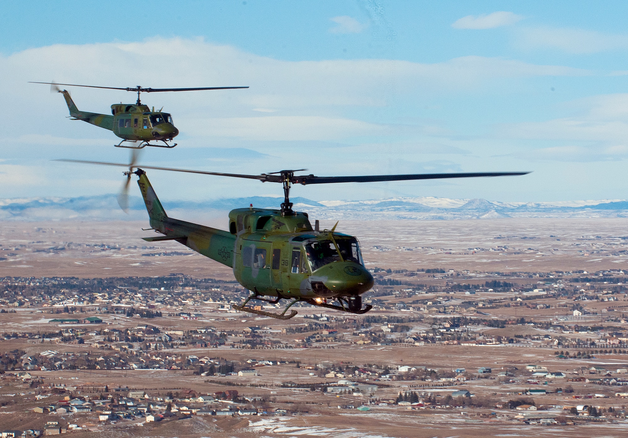 Two UH-1N helicopters from the 37th Helicopter fly in formation Jan 9, 2014, over Cheyenne, Wyo. The newly-formed 20th Air Force helicopter operations group set up at F.E. Warren Air Force Base Aug. 1, 2014. The group assumes control of the helicopter squadrons across 20th Air Force sometime in 2015 after it ends its provisional status. (Courtesy photo)
