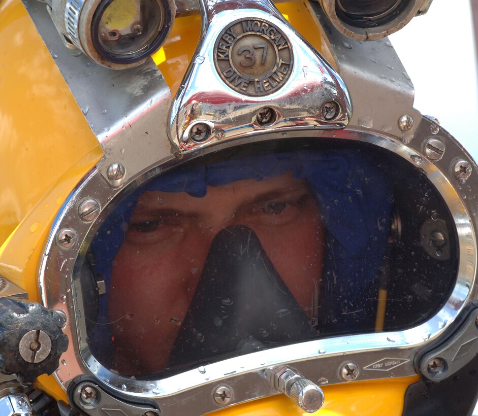 Diver Dustin Kelley, Nashville District Dive Team, looks out of his dive helmet after diving in Pickwick Lock in Counce, Tenn., to inspect after the gate shook and experienced a malfunction July 28, 2014.