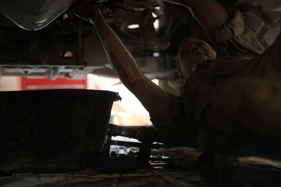 Lance Cpl. Matthew Whitaker, a motor transportation mechanic with 1st Battalion, 7th Marine Regiment, conducts maintenance from underneath a Mine-Resistant Ambush Protected vehicle aboard Camp Leatherneck, Afghanistan, July 22, 2014. Whitaker, a native of Bradley, Ill., and four other lance corporals are the five mechanics responsible for all maintenance performed on vehicles in the battalion to ensure mission success during combat operations.
(U.S. Marine Corps photo by Cpl. Joseph Scanlan / released)
