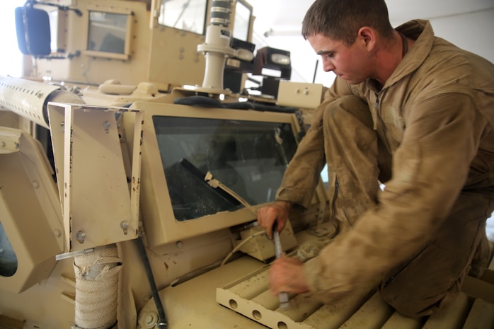 Lance Cpl. Andrew Witte, a motor transportation mechanic with 1st Battalion, 7th Marine Regiment, removes bolts from a Mine-Resistant Ambush Protected vehicle in order to replace a broken window aboard Camp Leatherneck, Afghanistan, July 22, 2014. Witte, a native of Phoenix, and four other lance corporals are the five mechanics responsible for all maintenance performed on vehicles in the battalion to ensure mission success during combat operations.
(U.S. Marine Corps photo by Cpl. Joseph Scanlan / released)

