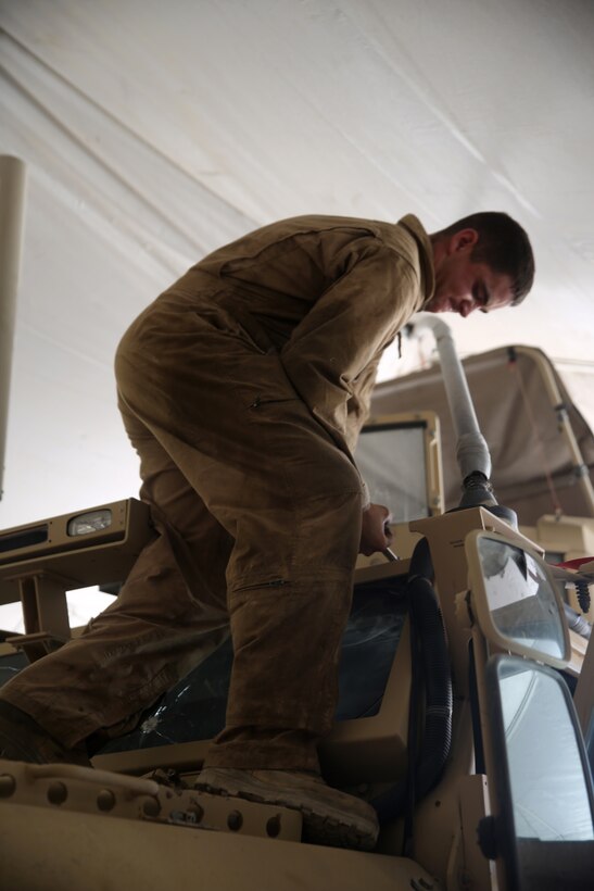 Lance Cpl. Andrew Witte, a motor transportation mechanic with 1st Battalion, 7th Marine Regiment, removes bolts from a Mine-Resistant Ambush Protected vehicle in order to replace a broken window aboard Camp Leatherneck, Afghanistan, July 22, 2014. Witte, a native of Phoenix, and four other lance corporals are the five mechanics responsible for all maintenance performed on vehicles in the battalion to ensure mission success during combat operations.
(U.S. Marine Corps photo by Cpl. Joseph Scanlan / released)
