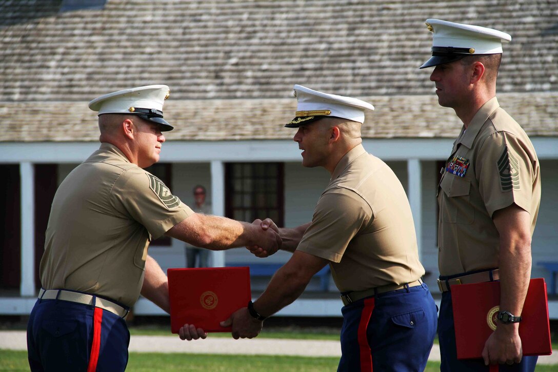 Master Sgt. Jeffery Loeffler shakes hands with Maj. Christopher Tsirlis, Commanding Officer of Marine Corps Recruiting Station Twin Cities, during his retirement ceremony. Loeffler retired after having served in the Marine Corps for 27 years. Loeffler spent 15 of those 27 years in Marine Corps Recruiting Station Twin Cities. The ceremony took place July 31 aboard Historic Fort Snelling. 