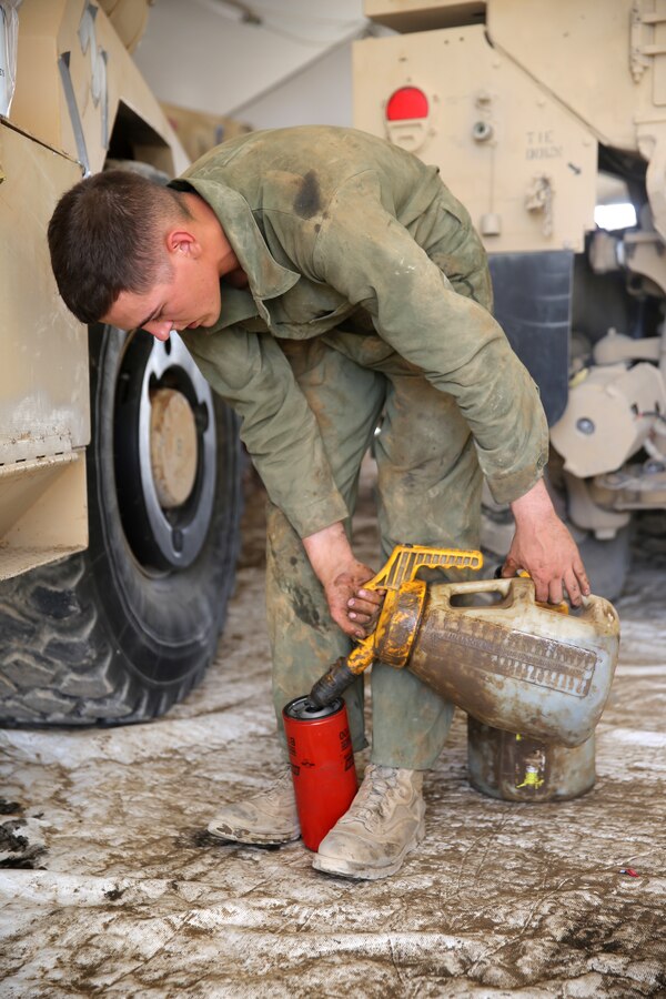Lance Cpl. Jordan Thomas, a motor transportation mechanic with 1st Battalion, 7th Marine Regiment, fills an oil filter before replacing an old one on a Mine-Resistant Ambush Protected vehicle aboard Camp Leatherneck, Afghanistan, July 22, 2014. Thomas, a native of Garvin, Minn., and four other lance corporals are the five mechanics responsible for all maintenance performed on vehicles in the battalion to ensure mission success during combat operations.
(U.S. Marine Corps photo by Cpl. Joseph Scanlan / released)
