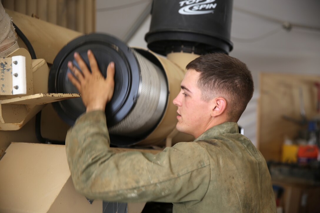 Lance Cpl. Jordan Thomas, a motor transportation mechanic with 1st Battalion, 7th Marine Regiment, replaces an air filter on a Mine-Resistant Ambush Protected vehicle aboard Camp Leatherneck, Afghanistan, July 22, 2014. Thomas, a native of Garvin, Minn., and four other lance corporals are the five mechanics responsible for all maintenance performed on vehicles in the battalion to ensure mission success during combat operations.
(U.S. Marine Corps photo by Cpl. Joseph Scanlan / released)
