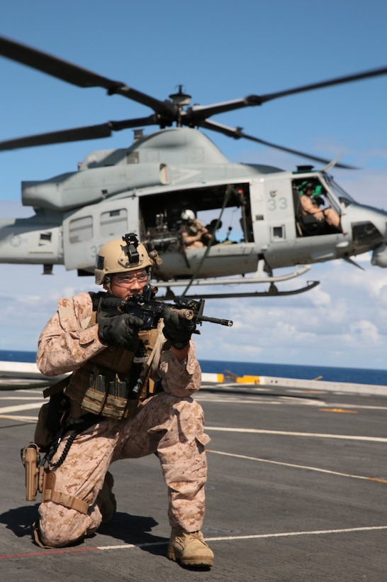 A Marine with the Force Reconnaissance Detachment, 11th Marine Expeditionary Unit, holds security on to the flight deck of the USS San Diego, Pacific Ocean, during fast-rope training, July 30, 2014. The 11th MEU and Makin Island Amphibious Ready Group are deployed as a sea-based, expeditionary crisis response force capable of conducting amphibious missions across the full range of military operations. 
Reconnaissance Marines are an integral portion of the 11th MEU's maritime interdiction capabilities, providing support during all full-mission profiles. (U.S. Marine Corps photo by Cpl. Jonathan R. Waldman/RELEASED)
