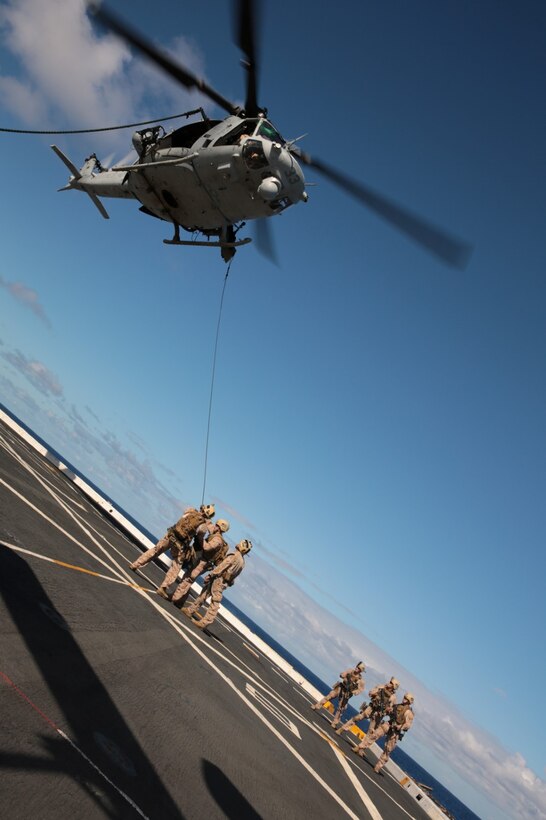 Marines with the Force Reconnaissance Detachment, 11th Marine Expeditionary Unit, guide a simulated casualty into a UH-1Y Super Huey from Marine Medium Tiltrotor Squadron 163 (Reinforced), 11th MEU July 30, 2014. The 11th MEU and Makin Island Amphibious Ready Group are deployed as a sea-based, expeditionary crisis response force capable of conducting amphibious missions across the full range of military operations. (U.S. Marine Corps photo by Cpl. Jonathan R. Waldman/RELEASED)