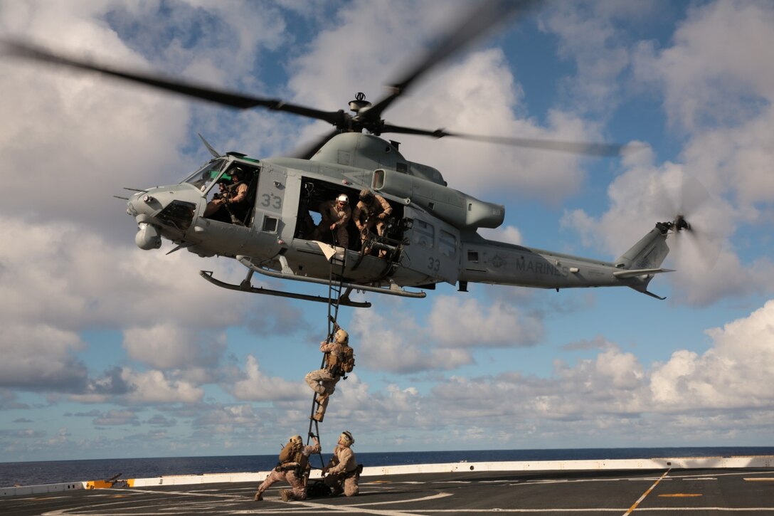 A Marine with the Force Reconnaissance Detachment, 11th Marine Expeditionary Unit, climbs a rope ladder from the flight deck of the USS San Diego into a UH-1Y Super Huey from Marine Medium Tiltrotor Squadron 163 (Reinforced), 11th MEU July 30, 2014. The 11th MEU and Makin Island Amphibious Ready Group are deployed as a sea-based, expeditionary crisis response force capable of conducting amphibious missions across the full range of military operations. (U.S. Marine Corps photo by Cpl. Jonathan R. Waldman/RELEASED)