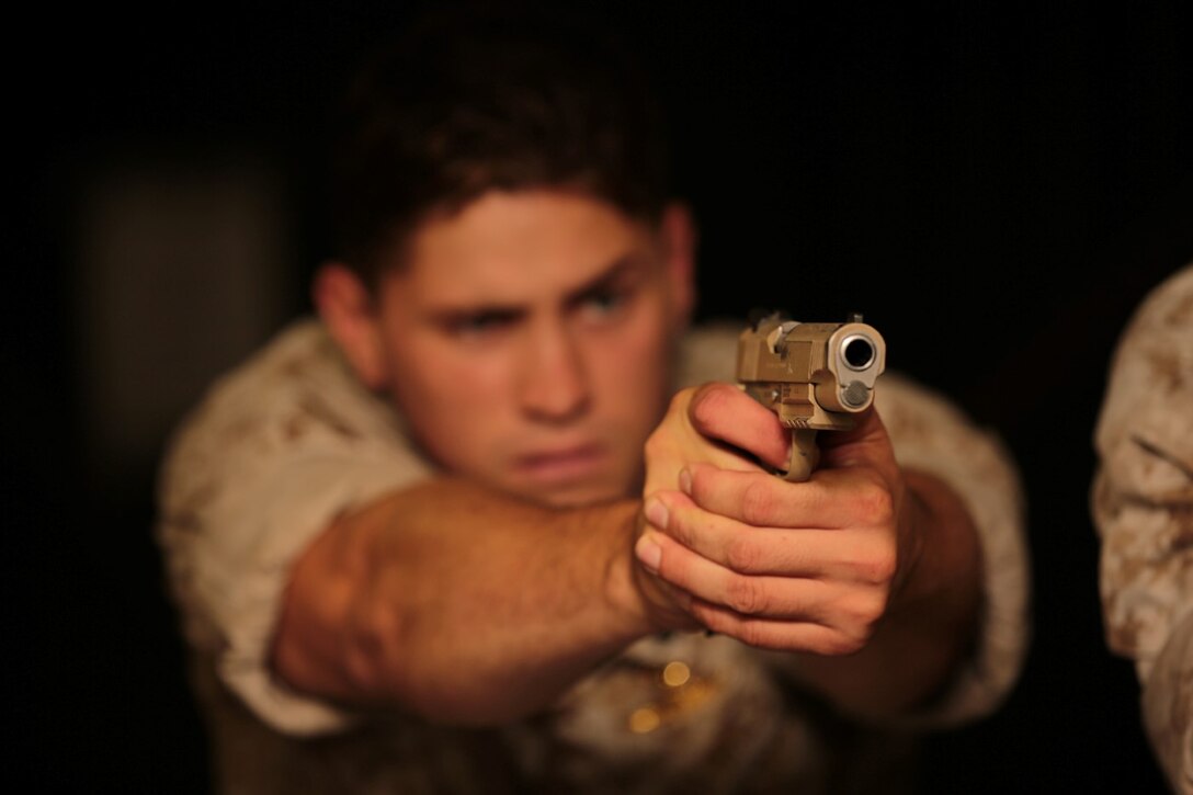 A Marine with the Force Reconnaissance Detachment, 11th Marine Expeditionary Unit, aims down the sights of a Marine Corps Close Quarters Battle Pistol during a weapons handling course aboard the USS San Diego, Pacific Ocean, July 31, 2014. The Marines of the Force Reconnaissance Detachment keep their skills current through practice and familiarization drills. (U.S. Marine Corps photo by Cpl. Jonathan R. Waldman/RELEASED)