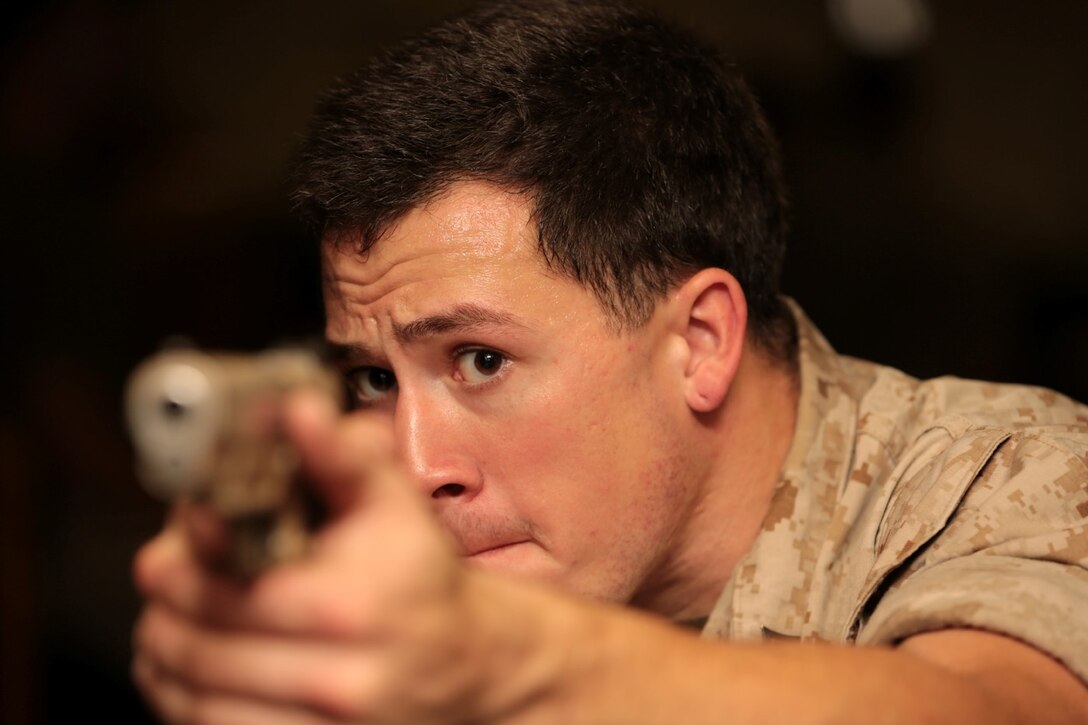 A Marine with the Force Reconnaissance Detachment, 11th Marine Expeditionary Unit, aims down the sights of a Marine Corps Close Quarters Battle Pistol during a weapons handling course aboard the USS San Diego, Pacific Ocean, July 31, 2014. The Marines of the Force Reconnaissance Detachment keep their skills current through practice and familiarization drills. (U.S. Marine Corps photo by Cpl. Jonathan R. Waldman/RELEASED)