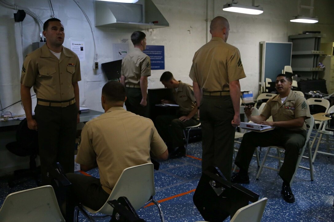 Marines with the 11th Marine Expeditionary Unit check in to Corporal’s Course, formal noncommissioned officer leadership training, aboard the USS Makin Island July 28, 2014. Marines with the 11th MEU who attend the formal noncommissioned officer leadership training will learn the basics of being a NCO in the United States Marine Corps. 