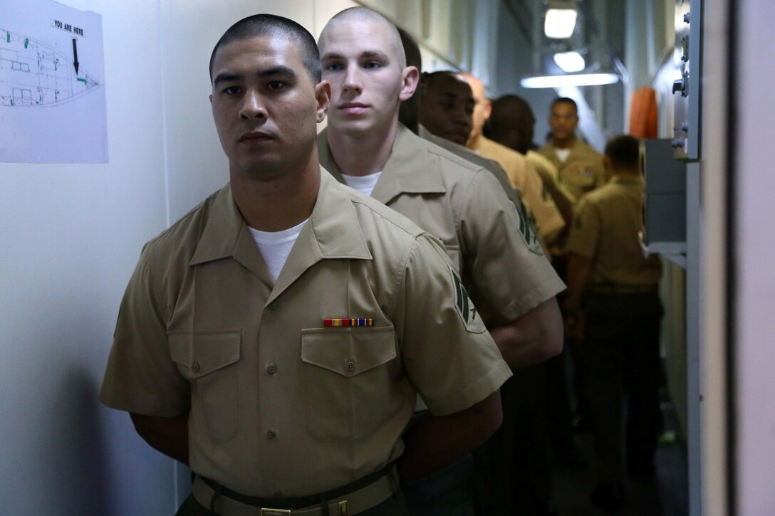 Marines with the 11th Marine Expeditionary Unit check in to Corporal’s Course, formal noncommissioned officer leadership training, aboard the USS Makin Island July 28, 2014. Marines with the 11th MEU who attend the formal noncommissioned officer leadership training will learn the basics of being a NCO in the United States Marine Corps. 